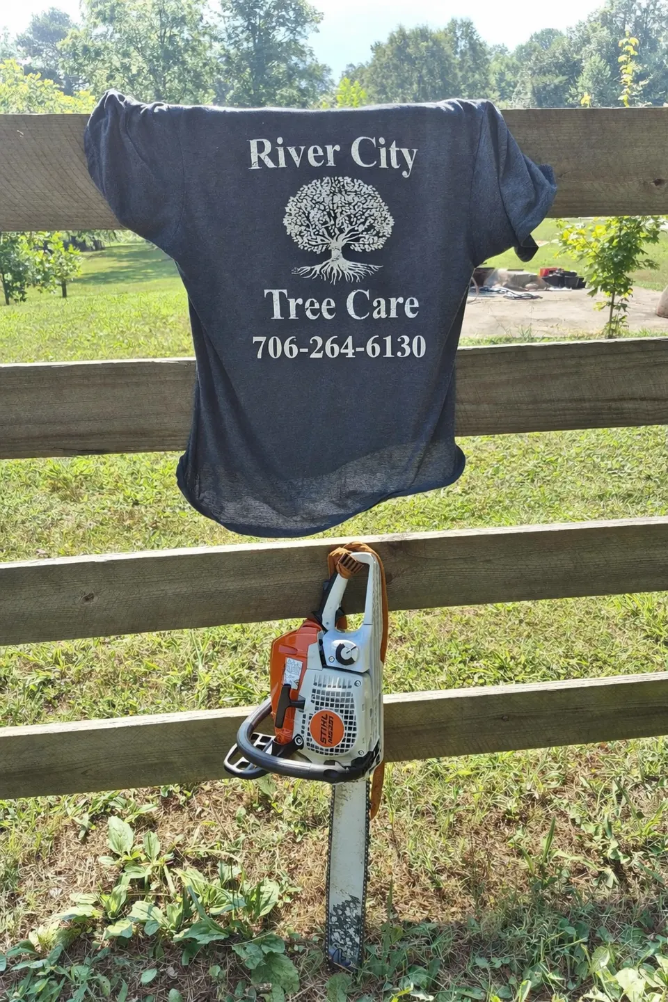 Andrew Roberson, owner of River City Tree Care, LLC — company shirt and chainsaw