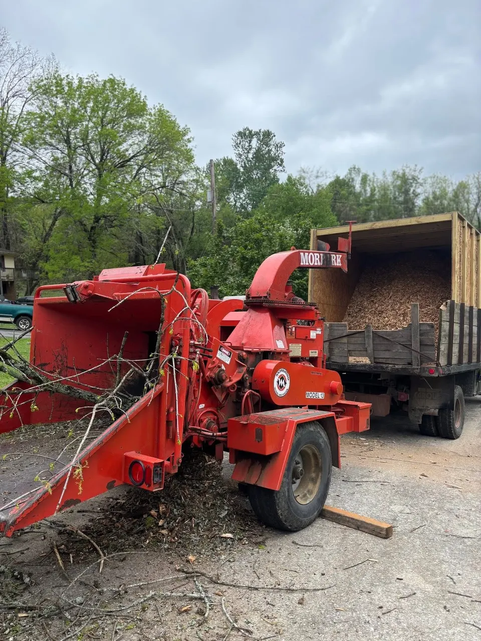 Wood chipper processing branches during tree trimming job in Chickamauga, GA